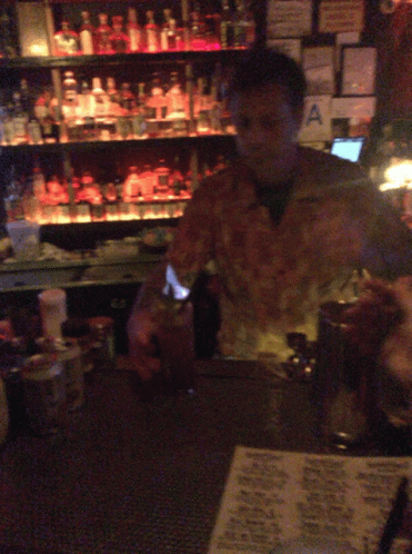 Man Behind Bar With Hawaiian Menu GIF