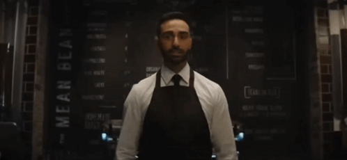 Man Behind Counter Arms Outstretched He's Baaack GIF