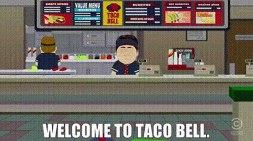 Man Behind Counter Saying Welcome to Taco Bell