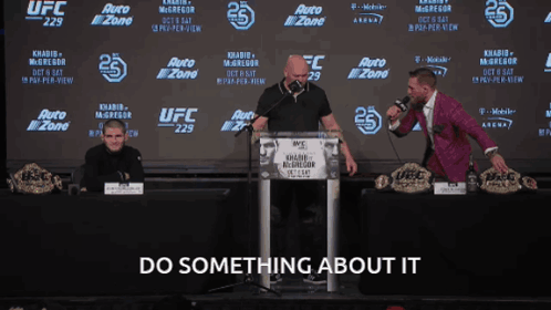 Man Behind Podium Do Something About It