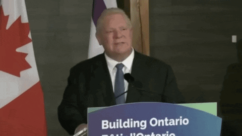 Man Behind Podium Saying Building Ontario
