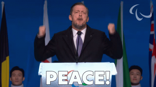 Man Behind Podium Saying Peace