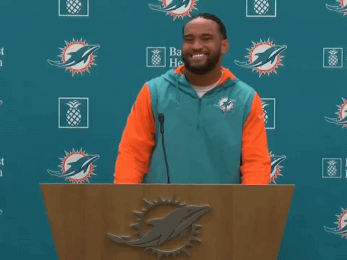 Man Behind Podium With Dolphin Logo GIF