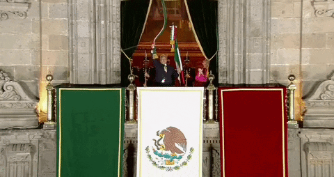 Man Behind Podium With Mexican Flag
