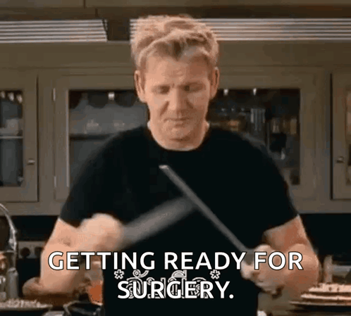 Man Black Shirt Holding Knife Spatula Getting Ready for Surgery