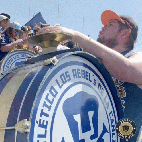Man Blowing Into Drum Los Rebels