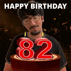 Man Blowing Out Candles on Birthday Cake Saying 82