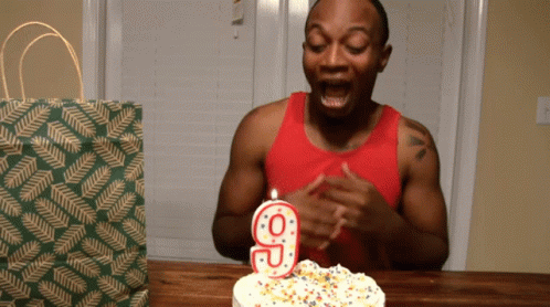 Man Blowing Out Number 9 Candle