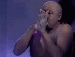 Man Blows Powder GIF