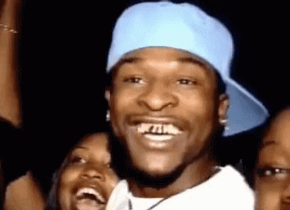 Man Blue Hat White Shirt Laughing with Two Women