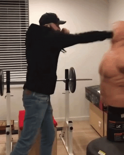 Man Boxing In Black Hoodie And Cap GIF