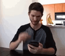 Man Browsing His Cellphone Head Scratching GIF
