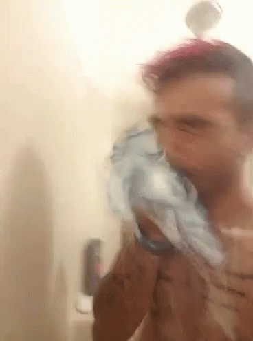 Man Brushing Teeth in Shower