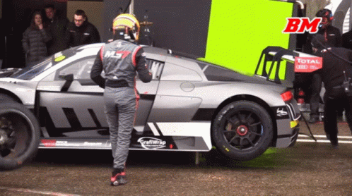 Man by Race Car Saying Total