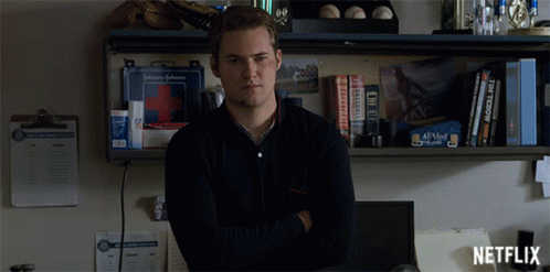 Man By Shelf With First Aid Kit And Netflix Logo GIF