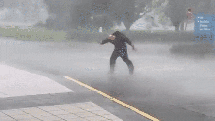 Man Carried By Hurricane Wind GIF