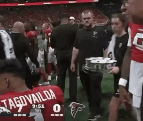 Man Carrying Beer Tray On Football Field GIF