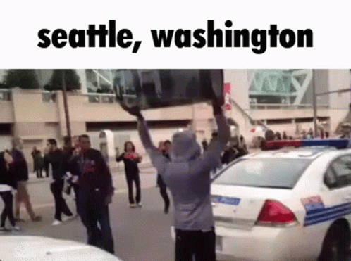 Man Carrying Large Object Over Head Seattle Washington