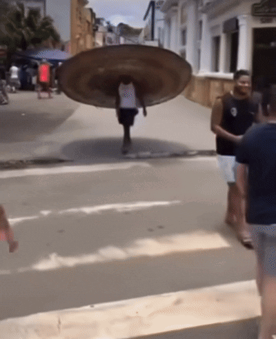 Man Carrying Large Plate on Back