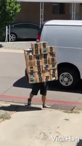 Man Carrying Stack Of Amazon Boxes On Back GIF