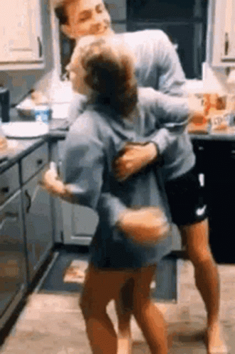 Man Carrying Woman in Kitchen