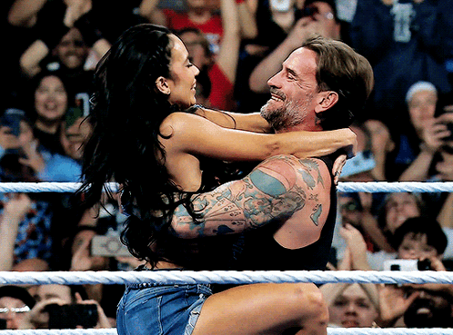Man Carrying Woman in Wrestling Ring