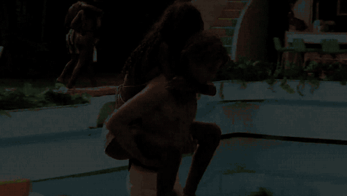Man Carrying Woman On Back In Swimming Pool GIF