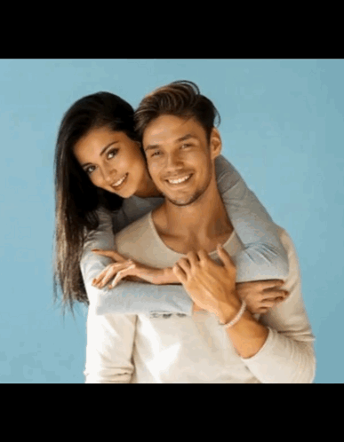 Man Carrying Woman on Back Smiling