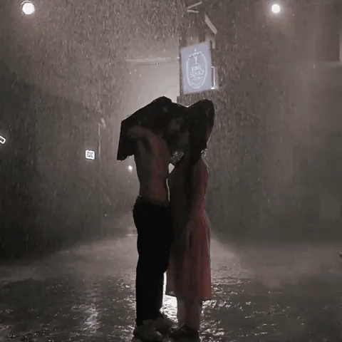 Man Carrying Woman on His Back in Rain