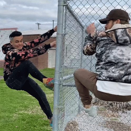 Man Climbing Chain Link Fence, Another Squats