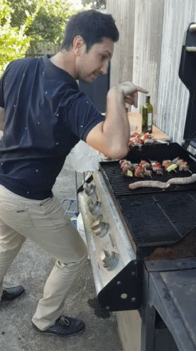 Man Cooking Food on Grill