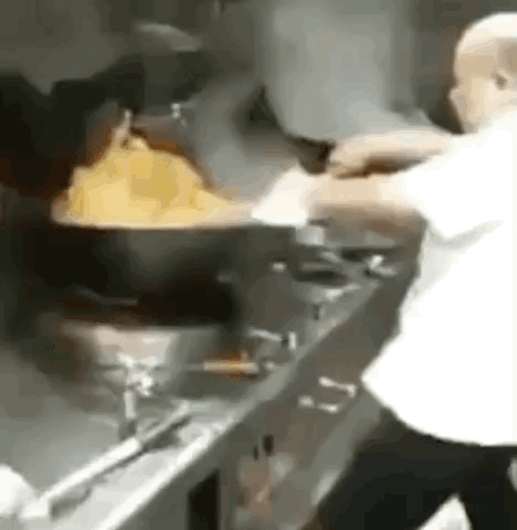 Man Cooking in Kitchen with Large Pot