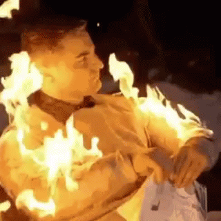 Man Covered in Flames Holding Fork