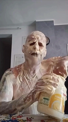 Man Covered in Mayonnaise Holding Jar