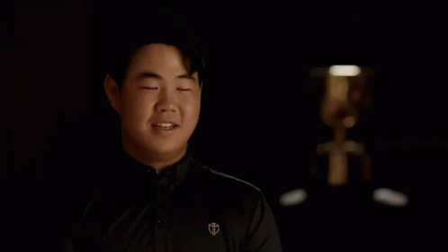 Man Covering Eyes In Dark Room GIF