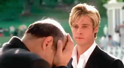 Man Covering Face as Another Looks On