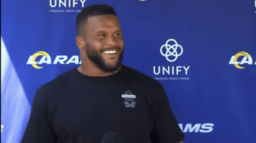 Man Covering Face at LA Rams Banner