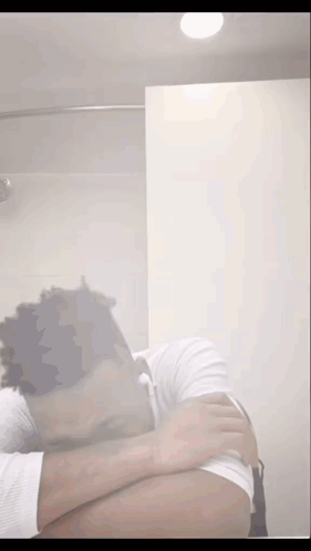 Man Covering Face in Bathroom
