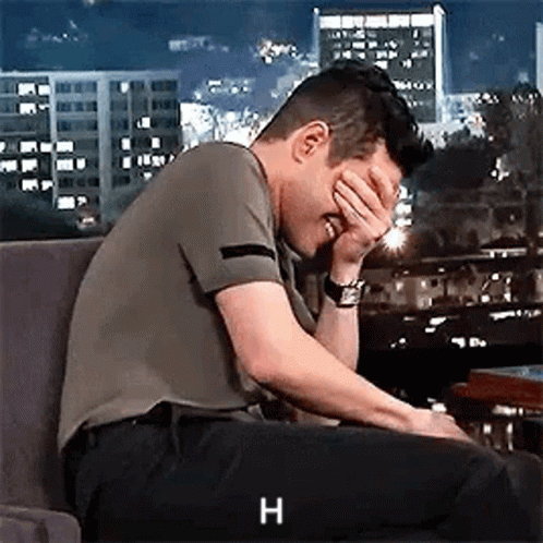 Man Covering Face in Chair