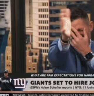 Man Covering Face In Front Of NY Giants Ad GIF