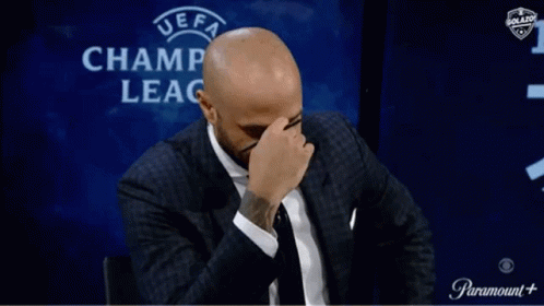 Man Covering Face in Front of UEFA Champ Leag