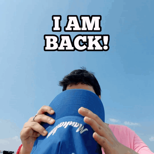 Man Covering Face With Blue Hat I Am Back GIF