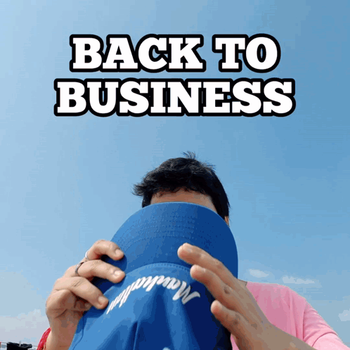 Man Covering Face With Blue Hat Saying Back to Business