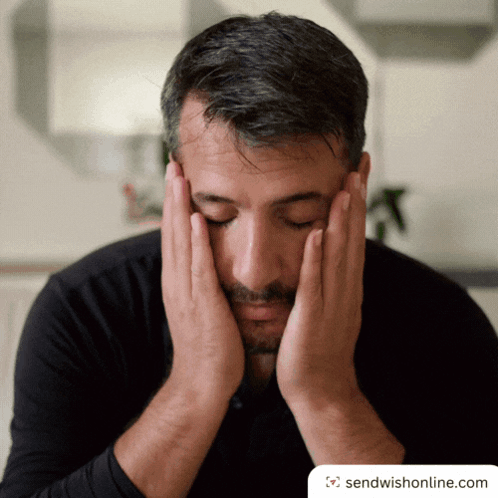 Man Covering Face with Hands