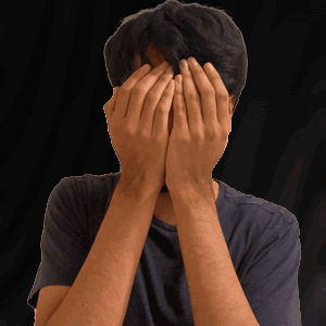 Man Covering Face With Hands In Black Shirt GIF