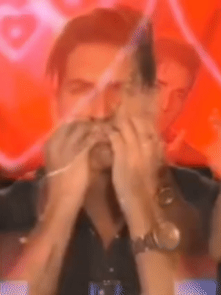 Man Covering Mouth in Front of Red Background