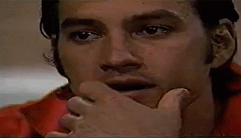 Man Covering Mouth With Hand In Red Shirt GIF