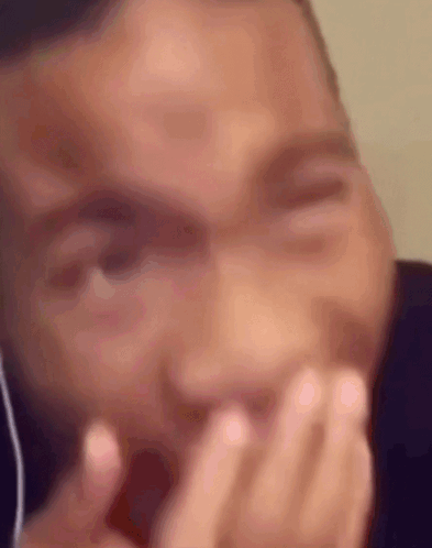 Man Covering Mouth with Headphones