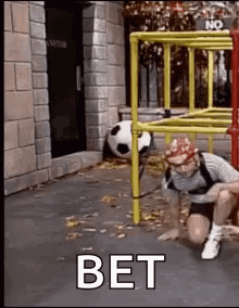 Man Crawling Under Ladder With Soccer Ball