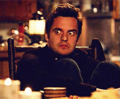 Man Cross-Legged In Chair Looking At Camera GIF